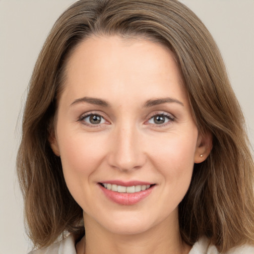 Joyful white young-adult female with medium  brown hair and brown eyes