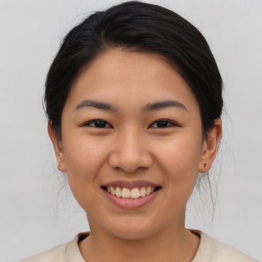 Joyful asian young-adult female with medium  brown hair and brown eyes