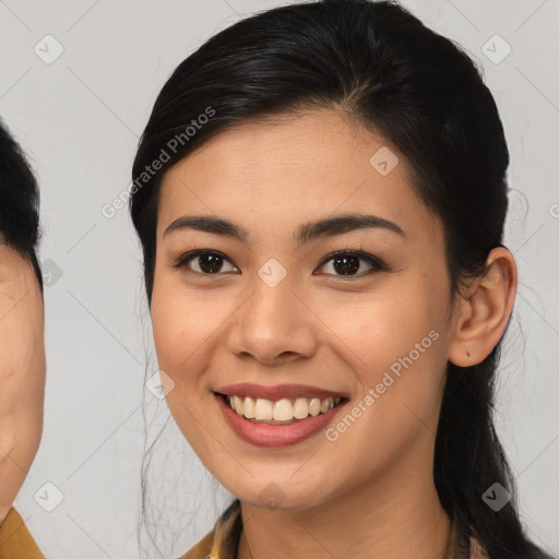 Joyful asian young-adult female with medium  brown hair and brown eyes