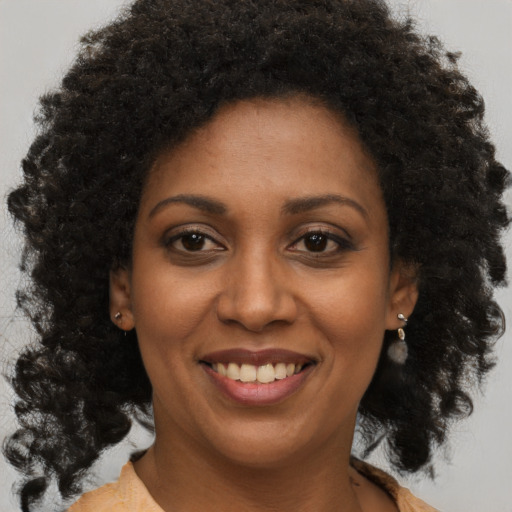 Joyful black young-adult female with medium  brown hair and brown eyes
