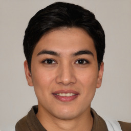 Joyful asian young-adult male with short  brown hair and brown eyes