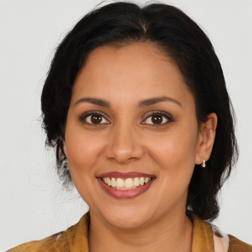 Joyful latino young-adult female with medium  brown hair and brown eyes