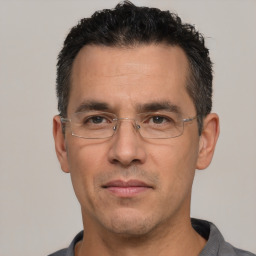 Joyful white adult male with short  black hair and brown eyes