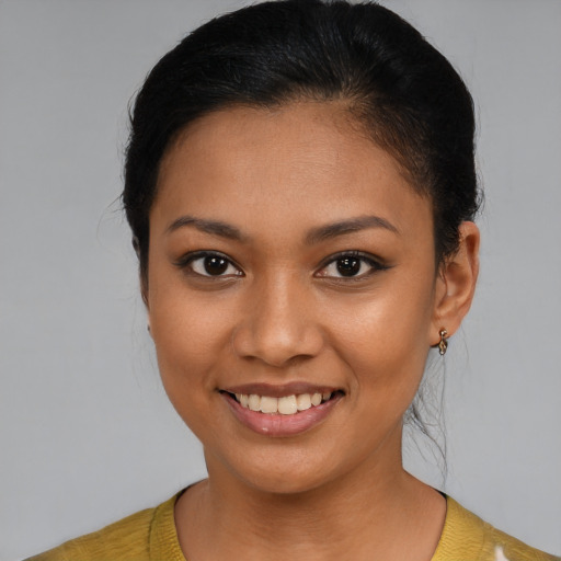 Joyful latino young-adult female with medium  brown hair and brown eyes