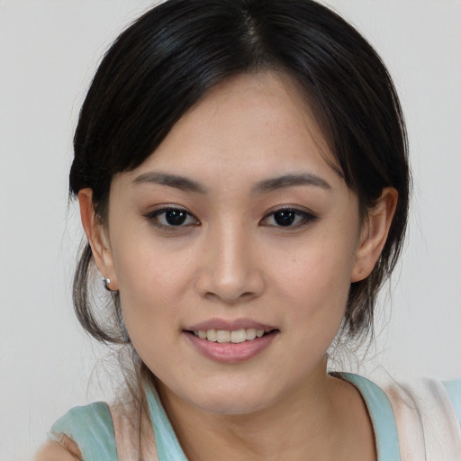 Joyful asian young-adult female with medium  brown hair and brown eyes