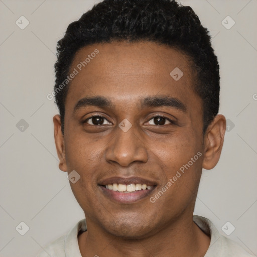 Joyful black young-adult male with short  black hair and brown eyes