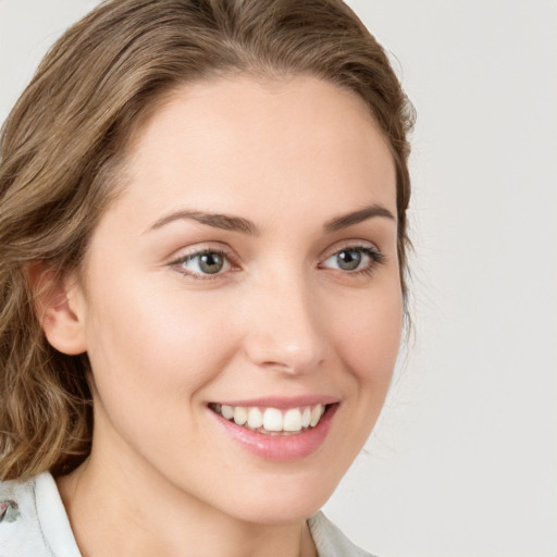 Joyful white young-adult female with medium  brown hair and green eyes