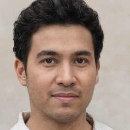 Joyful white young-adult male with short  black hair and brown eyes