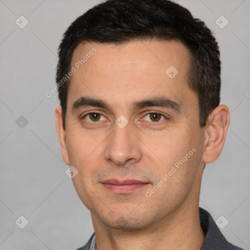 Joyful white young-adult male with short  black hair and brown eyes