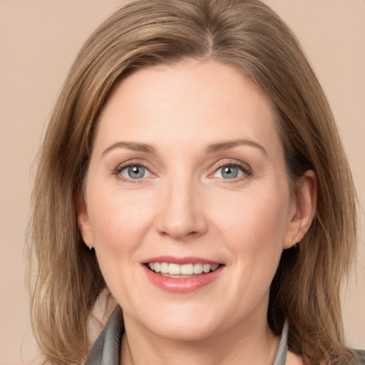 Joyful white adult female with medium  brown hair and grey eyes