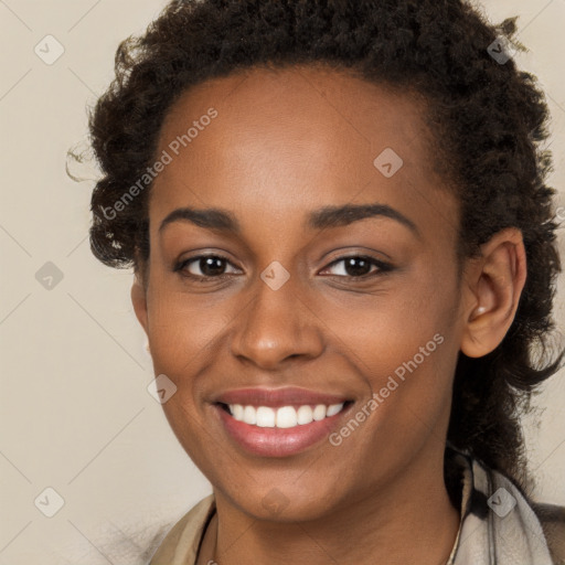 Joyful black young-adult female with long  brown hair and brown eyes