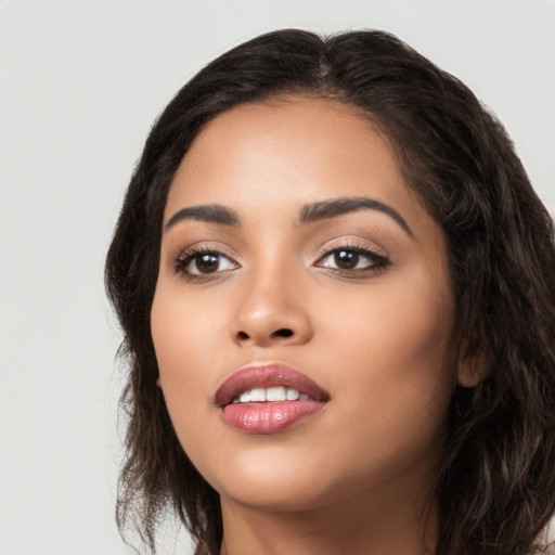 Joyful latino young-adult female with long  black hair and brown eyes