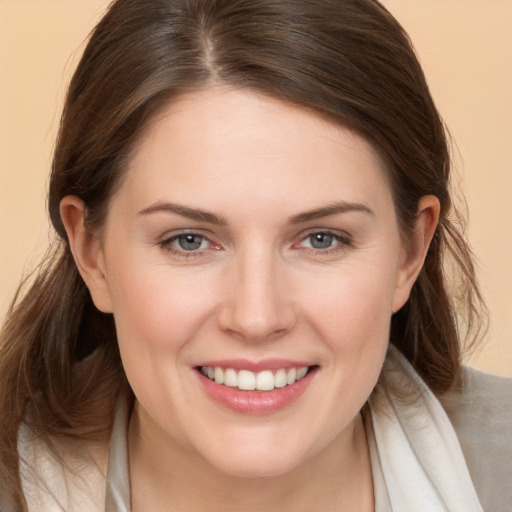 Joyful white young-adult female with long  brown hair and brown eyes