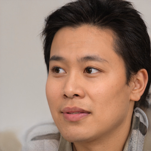 Joyful black young-adult male with medium  brown hair and brown eyes