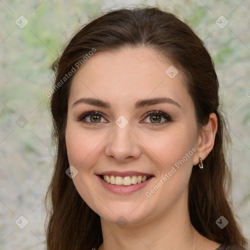 Joyful white young-adult female with long  brown hair and green eyes