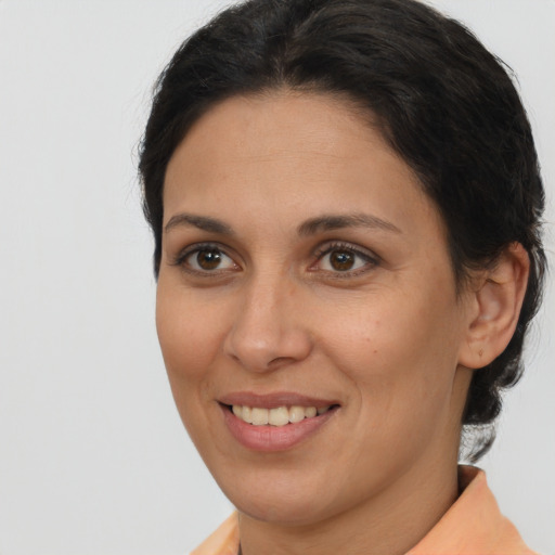 Joyful white adult female with medium  brown hair and brown eyes