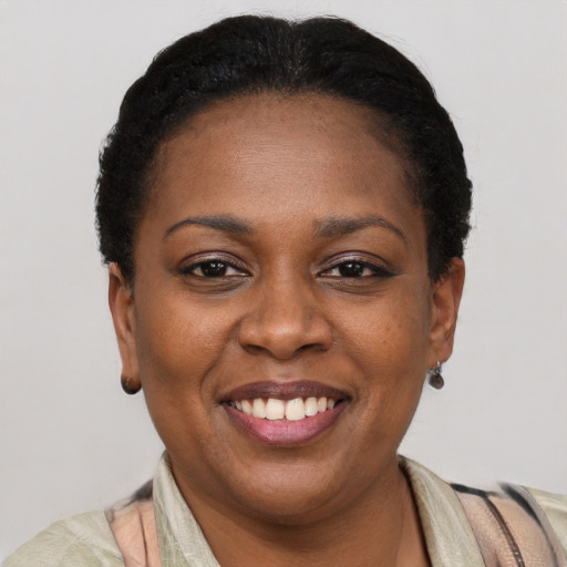 Joyful black adult female with short  brown hair and brown eyes