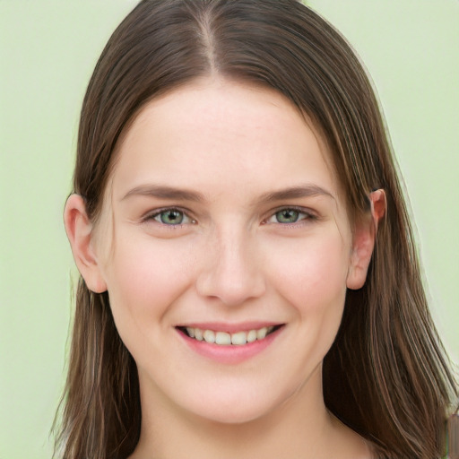 Joyful white young-adult female with long  brown hair and green eyes