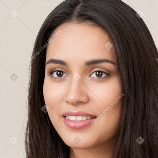 Joyful white young-adult female with long  black hair and brown eyes