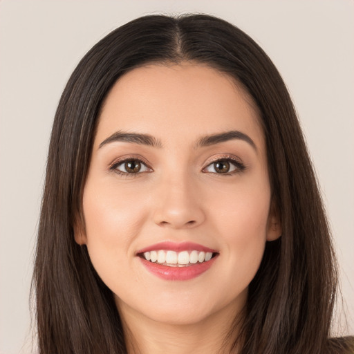 Joyful white young-adult female with long  brown hair and brown eyes