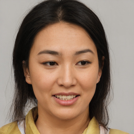 Joyful asian young-adult female with medium  brown hair and brown eyes