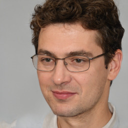 Joyful white adult male with short  brown hair and brown eyes