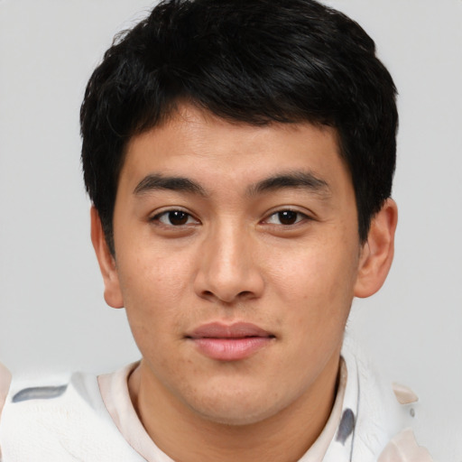 Joyful asian young-adult male with short  brown hair and brown eyes