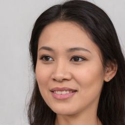 Joyful asian young-adult female with long  brown hair and brown eyes