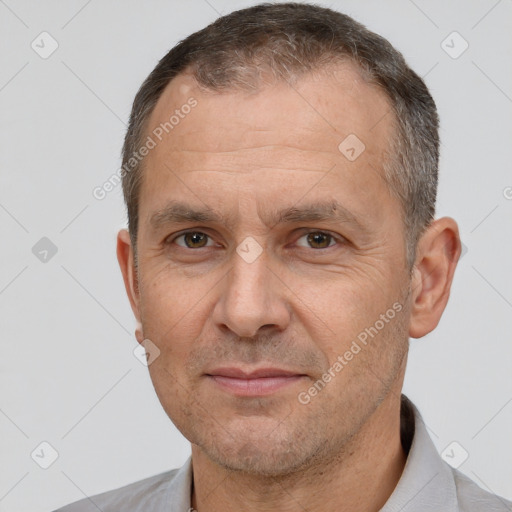 Joyful white adult male with short  brown hair and brown eyes