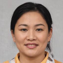 Joyful asian young-adult female with medium  brown hair and brown eyes