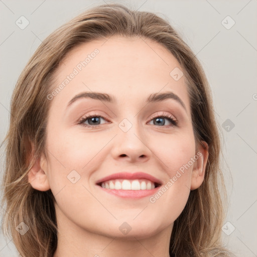 Joyful white young-adult female with long  brown hair and grey eyes