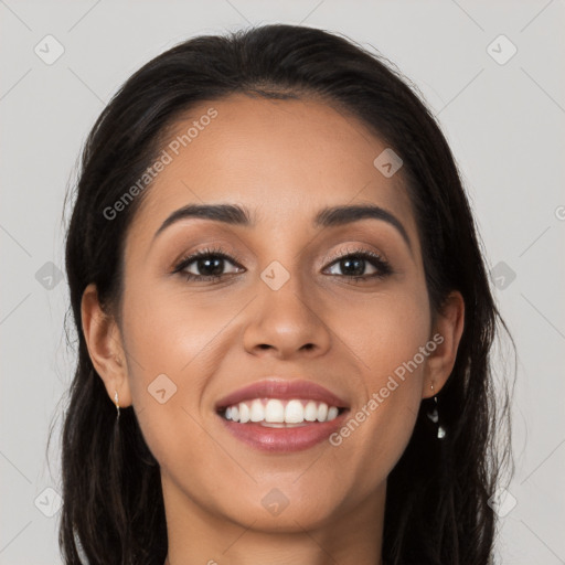 Joyful latino young-adult female with long  brown hair and brown eyes