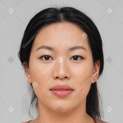 Joyful asian young-adult female with medium  black hair and brown eyes