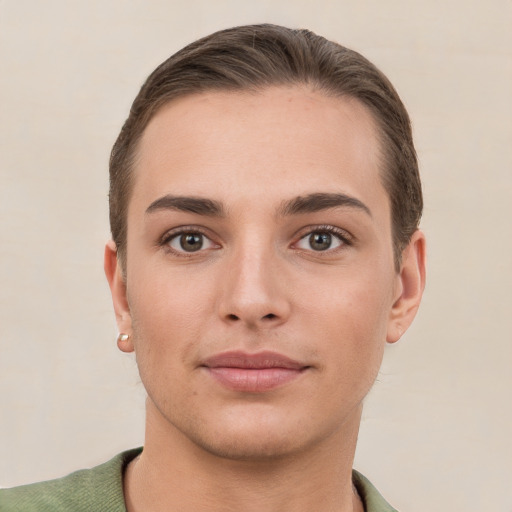 Joyful white young-adult female with short  brown hair and grey eyes