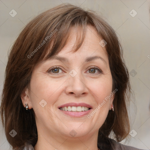 Joyful white adult female with medium  brown hair and grey eyes