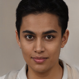 Joyful latino young-adult male with short  brown hair and brown eyes