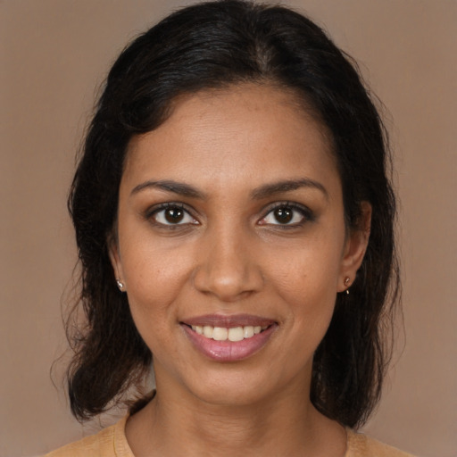 Joyful black young-adult female with medium  brown hair and brown eyes