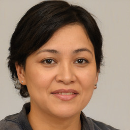 Joyful white adult female with medium  brown hair and brown eyes