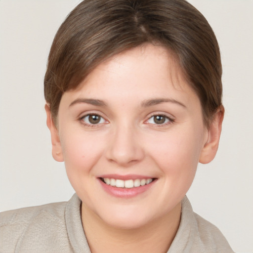 Joyful white young-adult female with short  brown hair and brown eyes