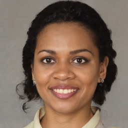 Joyful black young-adult female with medium  brown hair and brown eyes