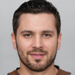 Joyful white young-adult male with short  brown hair and brown eyes