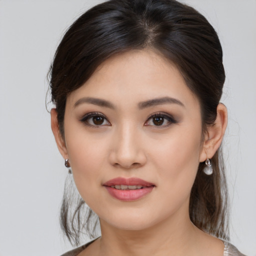 Joyful asian young-adult female with medium  brown hair and brown eyes