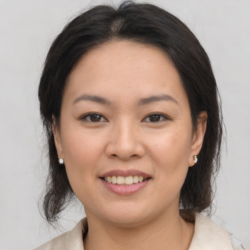 Joyful white young-adult female with medium  brown hair and brown eyes