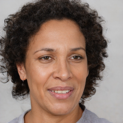 Joyful black adult female with medium  brown hair and brown eyes