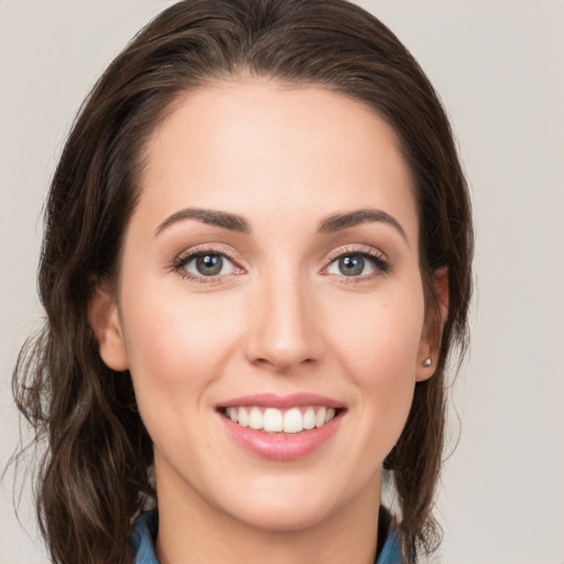 Joyful white young-adult female with medium  brown hair and green eyes