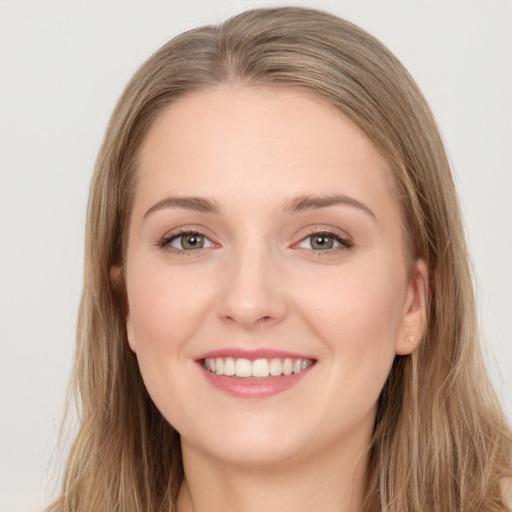 Joyful white young-adult female with long  brown hair and grey eyes