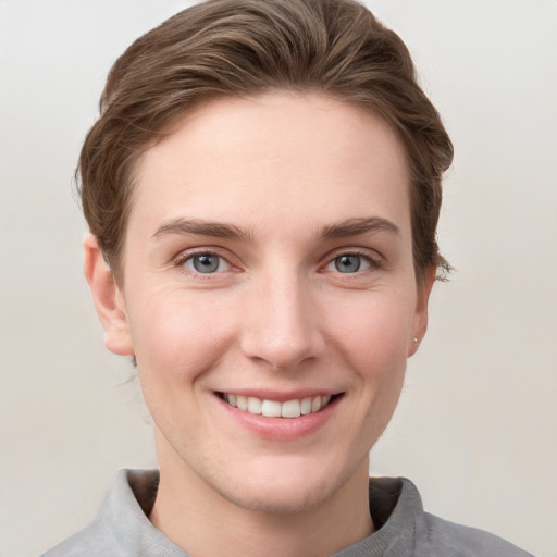 Joyful white young-adult female with short  brown hair and grey eyes