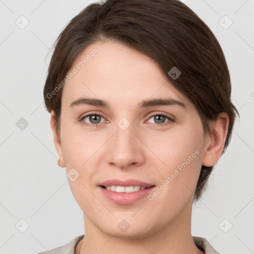 Joyful white young-adult female with short  brown hair and grey eyes