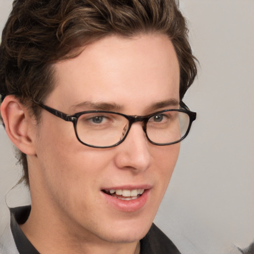 Joyful white young-adult male with short  brown hair and blue eyes