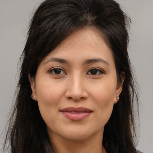 Joyful asian young-adult female with long  brown hair and brown eyes